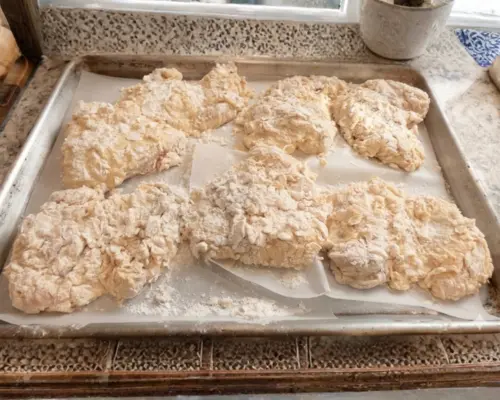 KFC Nashville Hot Chicken Combos are Back in 2026 15 Chicken pieces heavily coated in a craggy flour breading, ready to be fried into crispy KFC Nashville Hot Tenders.