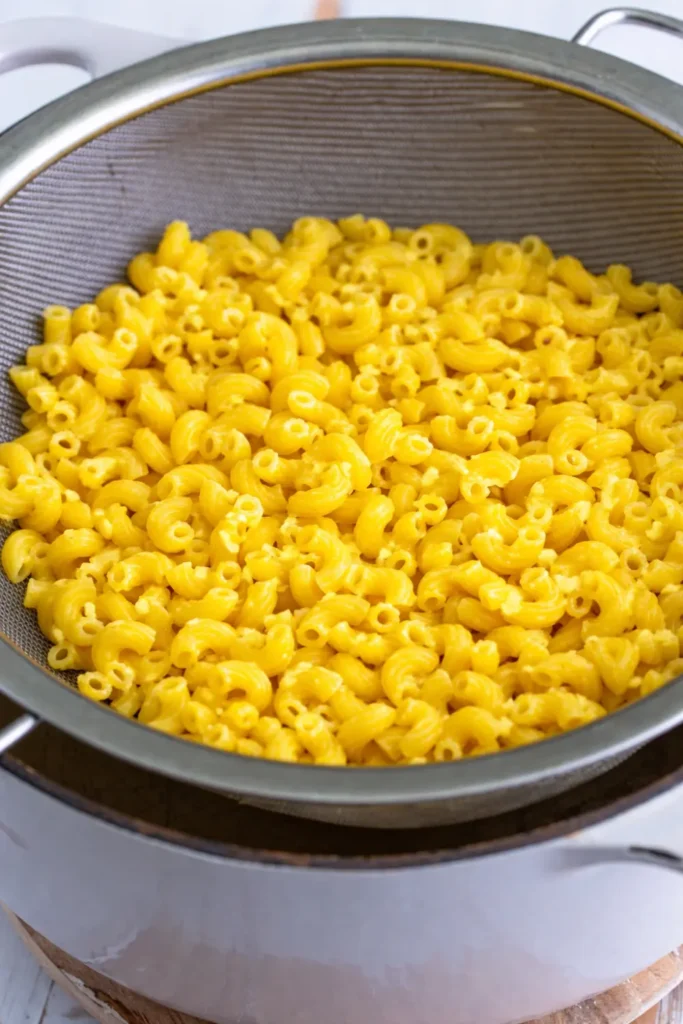 Copycat KFC Mac and Cheese Recipe, Calories & Nutrition Guide 2026 5 the first step for copycat homemade kfc mac and cheese recipe in which macaroni are added.